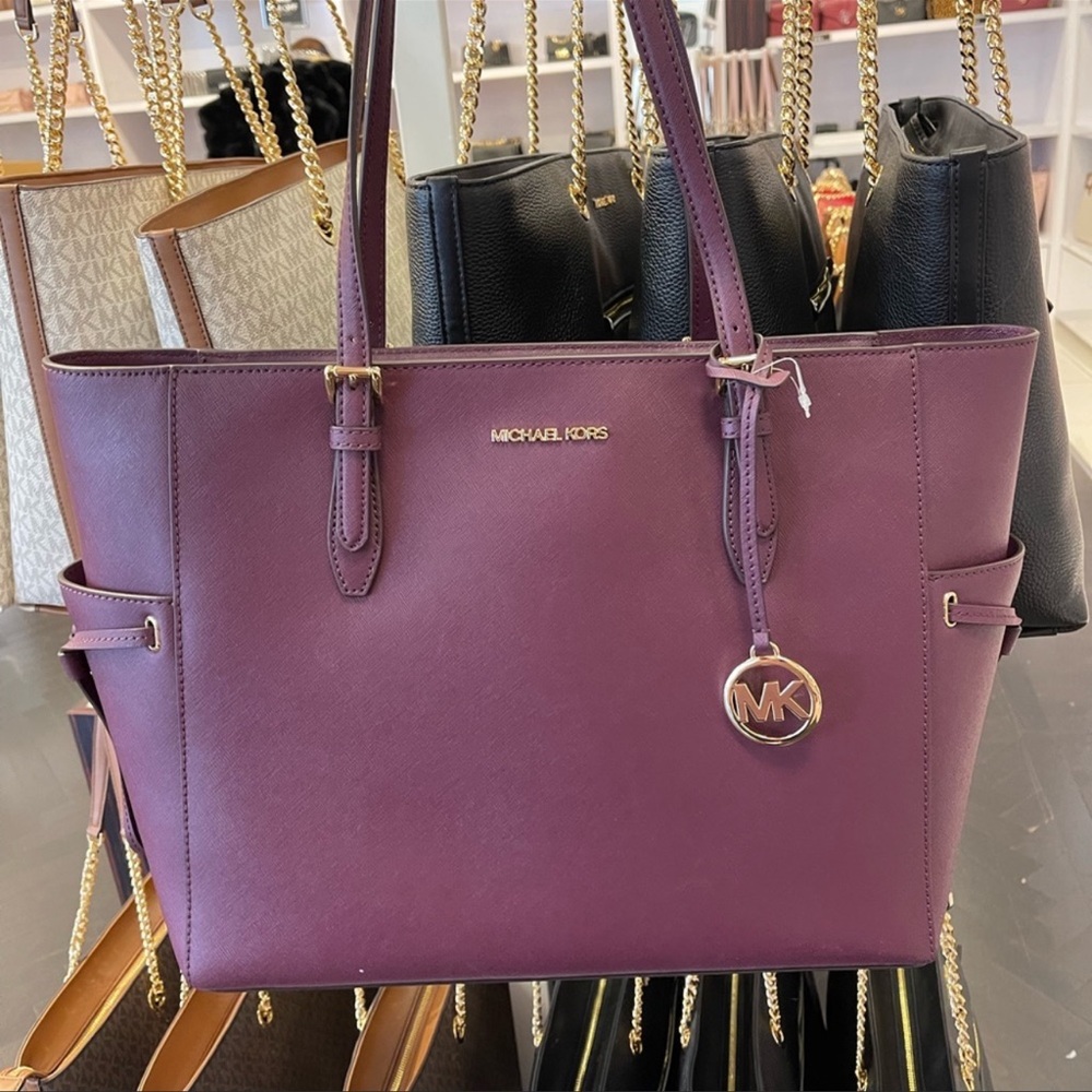Michael Kors Gilly large travel drawstring leather top zip tote. Bordeaux color
